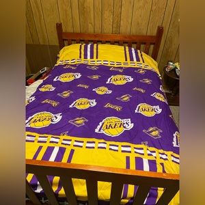 A twin comforter. The main colors are purple and yellow.